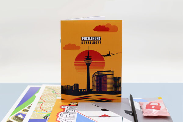 Produktbild Puzzlehunt Düsseldorf Rätseltour, Broschüre und Inhalt des Spiel-Kits